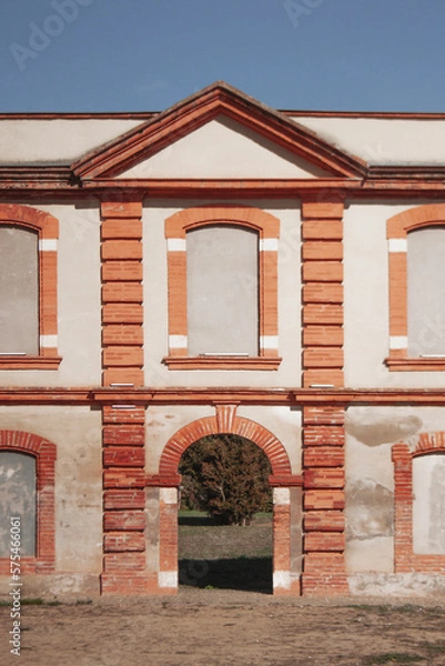 Obraz Façade of an old classic building. Brick architecture. Pediment over the blue sky.