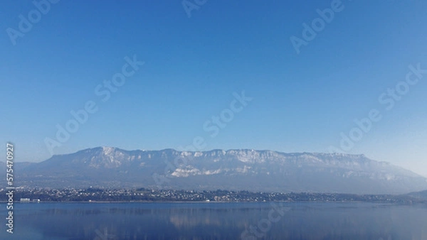 Obraz View over a lake. Blue sky and mountain.