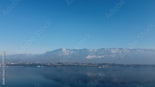 Obraz View over a lake. Blue sky and mountain.