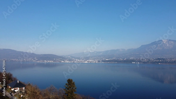 Obraz View over a lake. Blue sky and mountain.