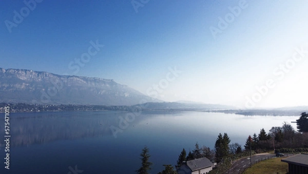 Obraz View over a lake. Blue sky and mountain.