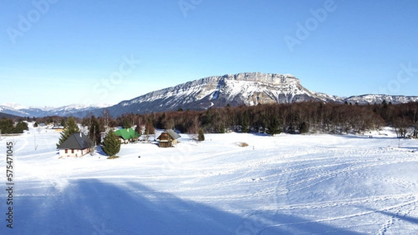 Obraz Panoramic view of snowy mountains in winter. Foggy mountains. Woods in front of the mountains. Mountains resort station.