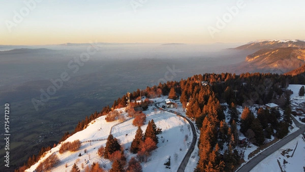 Obraz Winter view over a mountain covered with trees. Foggy sunset background.