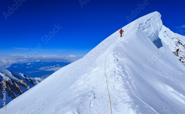 Obraz A climber reaching the summit of Mt Denali in Alaska, the highest peak in North America