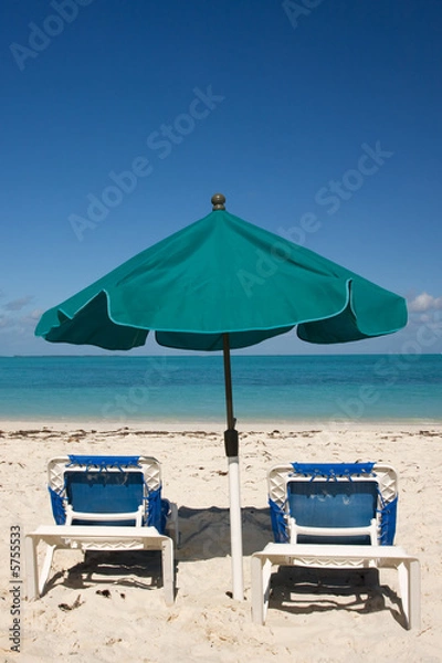 Fototapeta green sun umbrella and two loungers on tropical beach