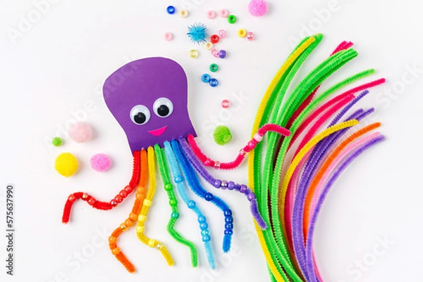 Fototapeta Funny octopus made of beads and pipe cleaners with different colorful and materials for DIY art activity for kids. Cute children's crafts, creativity and hobby. Development of fine motor skills