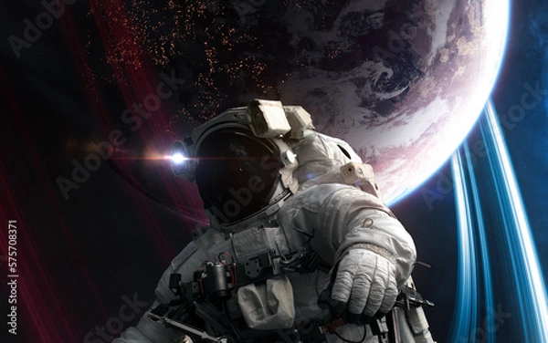 Fototapeta Astronaut in outer space in front of distant inhabited planet. Science fiction. Elements of this image furnished by NASA