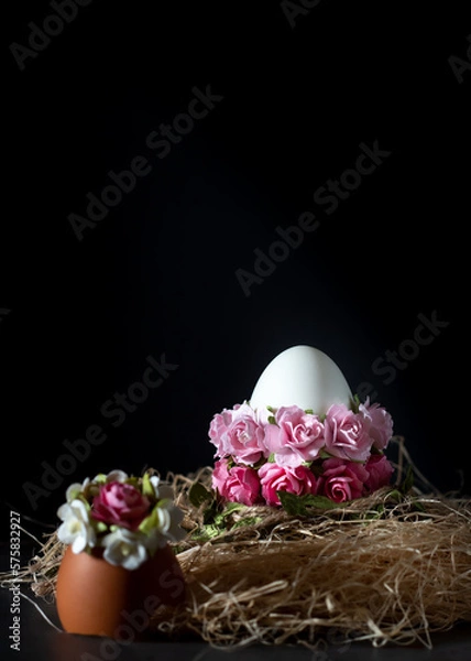 Fototapeta Easter egg with pink flowers on a black background with copy space
