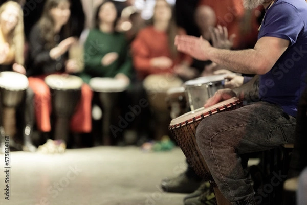 Fototapeta A large group of people playing the conga drums in a relaxed setting
