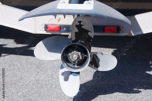 Fototapeta Outboard boat engine propeller isolated on land