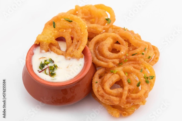 Fototapeta Indian Kesari Jalebi Also Called Jilapi, Jilebi, Jilipi, Zulbia, Jerry, Zalebi, Mushabak Topped With Creamy Lachhedar Malai Rabri Also Called Khurchan Rabdi, Lachha Rabidi Consumed On Diwali And Holi