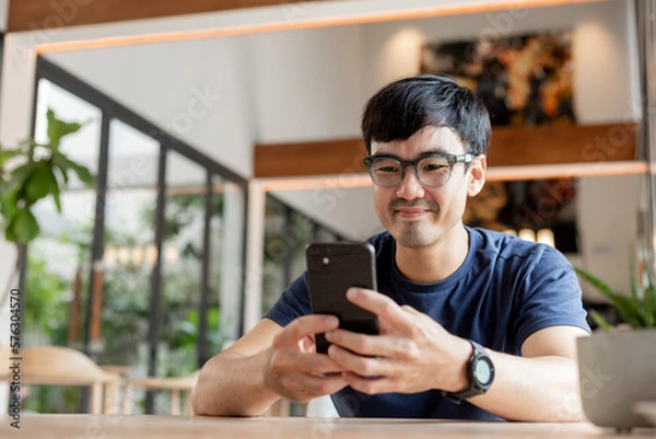 Fototapeta man using cell phone hand holding mobile texting message contact us.chatting,search internet information.technology device communication connecting