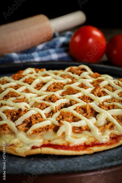 Obraz Chicken pizza with creamy cheese (catupiry) with tomatoes and a rolling pin in the background