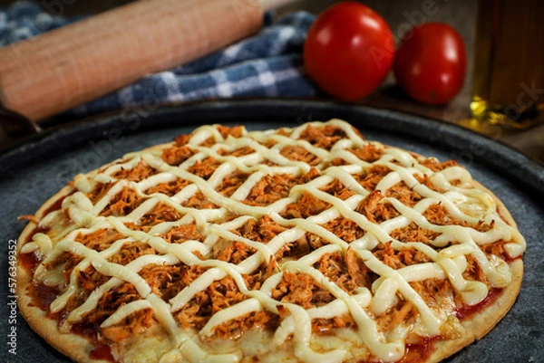 Obraz Chicken pizza with creamy cheese (catupiry) with tomatoes and a rolling pin in the background