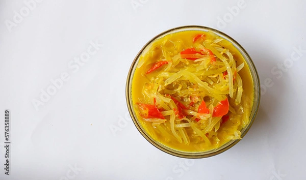 Fototapeta Lodeh pepaya muda, dish with coconut milk sauce is one of the side dishes in Indonesia which is made from unripe papaya on a white background.  Suitable for the lunch menu eaten with warm rice.
