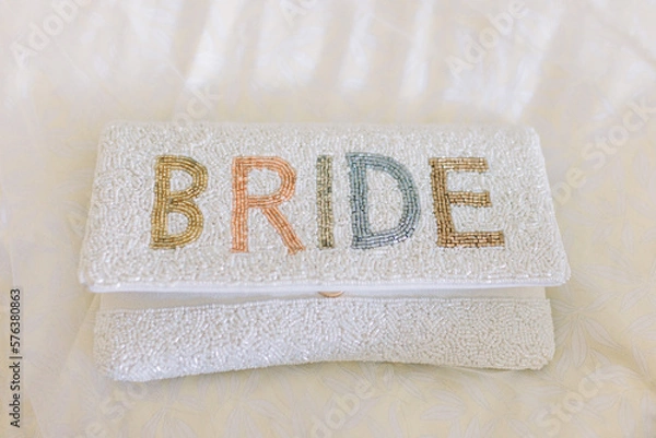 Obraz A bride's white clutch with the words "Bride" in colorful letters.