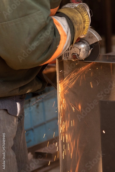 Fototapeta cutting metal with an angle grinder