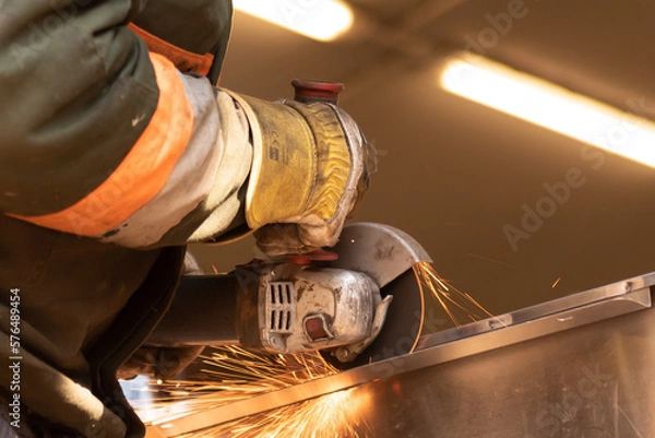 Fototapeta cutting metal with an angle grinder