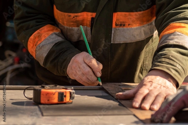 Fototapeta cutting metal with an angle grinder,wood, worker, carpenter, work, construction, tool, working, diy, home, equipment, craftsman, job, people, tools, hand, repair, person, woman, building, carpentry, h