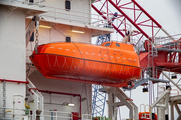 Fototapeta Rescue boat hanging from a ship 