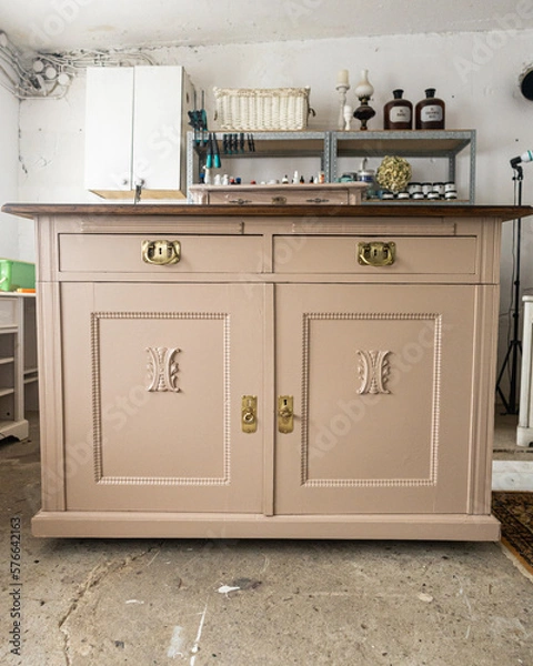 Fototapeta Oak chest of drawers after renovation painted beige. Photos from the workshop.