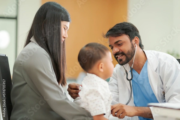 Fototapeta A kind doctor who treats pediatric patients. The child and his family brought him to see the doctor at the hospital because he was ill.