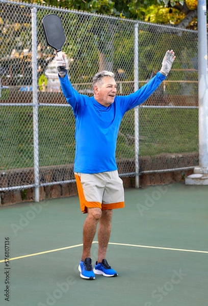 Obraz Active Senior Man playing Pickle Ball outdoors