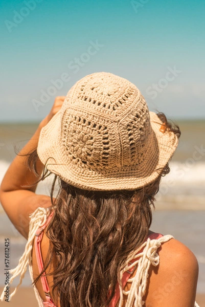 Obraz woman on the beach wearing crochet hat .Outfit spring summer