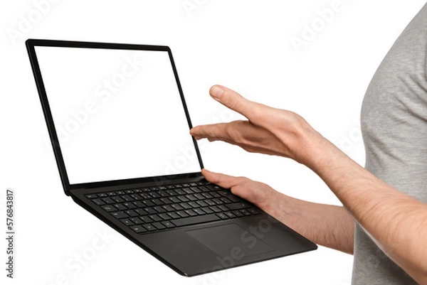 Fototapeta A man in a T-shirt holds a laptop, an ultrabook and points to the screen with his hand.