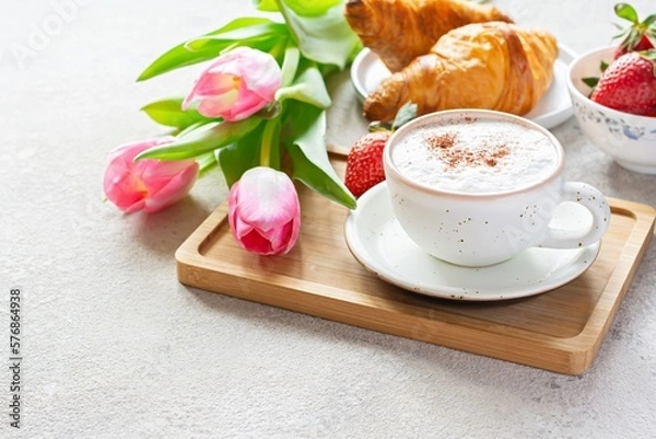 Obraz Happy mother's day, beautiful breakfast, lunch with cup of coffee (cappuccino) fresh croissants, strawberries on tray, bouquet of tulips as gift. Festive concept. Spring holiday, family relations.