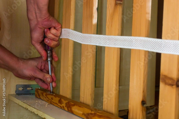 Fototapeta Assembly of the bed with a screwdriver