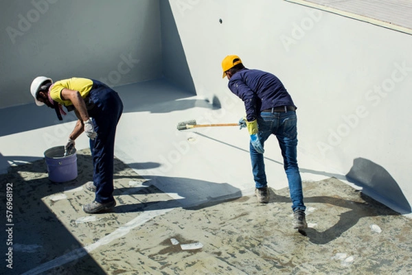 Fototapeta Applying epoxy paint on a surface of a pool