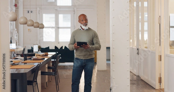 Fototapeta Planning, networking and black man in real estate with a tablet, reading email and search for property online. Connection, typing and senior African realtor walking with tech for communication on web