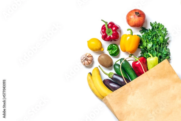 Fototapeta Eco friendly paper shop bag with raw organic green vegetables isolated on white background Flat lay, top view Zero waste, plastic free concept Healthy clean eating diet and detox, agriculture concept