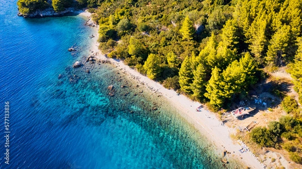 Fototapeta The stunning beauty of Croatia's rocks and forests is captured in this breathtaking aerial view. Take in the turquoise waters and beach from above, and add this travel image to your collection of unfo