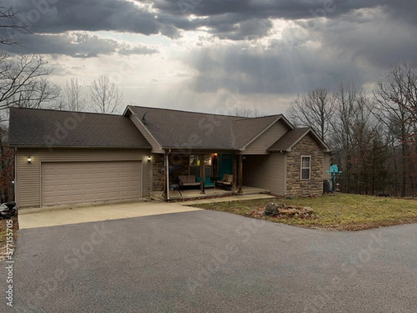 Fototapeta View of a typical suburban house with a stormy sky