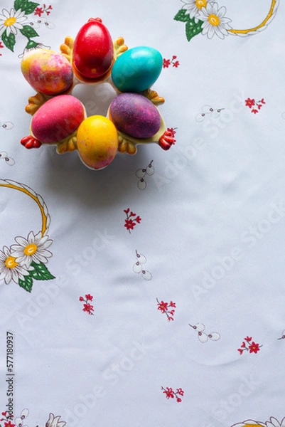 Obraz Top view of colored easter eggs on a white tablecloth