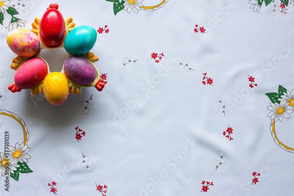 Obraz Top view of colored easter eggs on a white tablecloth