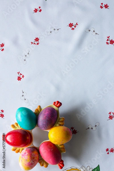 Obraz Top view of colored easter eggs on a white tablecloth