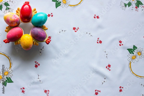 Obraz Top view of colored easter eggs on a white tablecloth