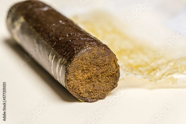 Fototapeta Indian Manali Charas, high quality resin hashish on a white background. Medical marijuana extraction hash cannabis pollen oil