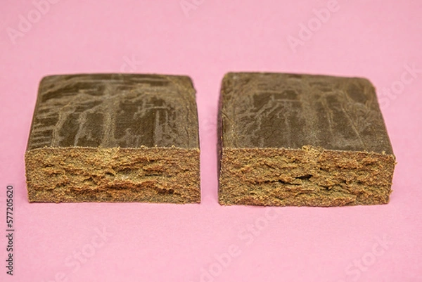 Fototapeta Peach ozz dry base hash. Medical marijuana extraction super dry hashish high quality cannabis pollen on a pink background.