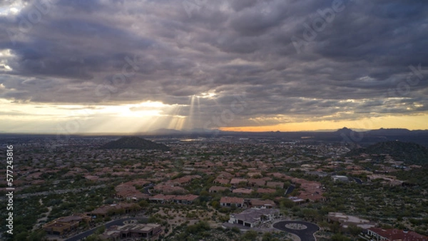 Fototapeta An aerial view of the Mesa Arizona valley with dramatic clouds and sun rays.