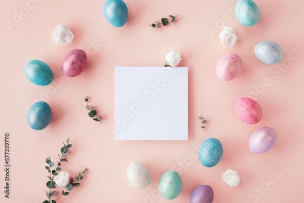 Fototapeta Easter spring concept. Top view photo of empty square blank, colorful eggs and flowers on pastel table.