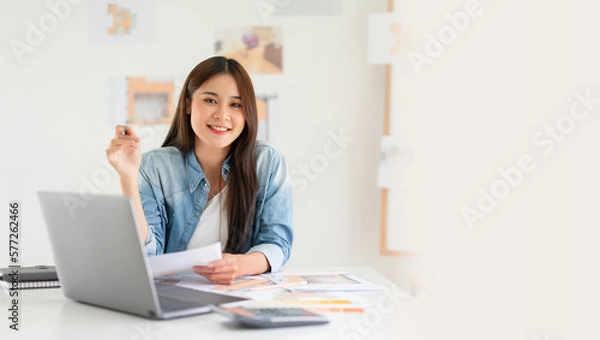 Fototapeta Banner with blank copyspace, Design building concept, Female architect holding blueprint of house plan and smiling on camera