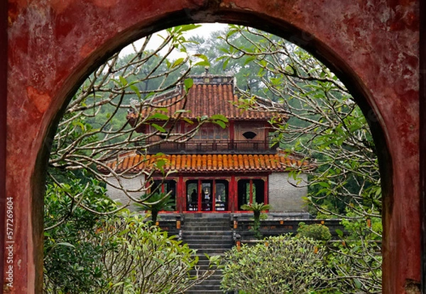 Obraz Pavilion inside Minh Mang Emperor Mausoleum viewed through arch gate in Hue, Vietnam on October 10, 2022
