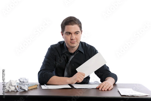 Fototapeta Business man sitting at desk holding blank envelope
