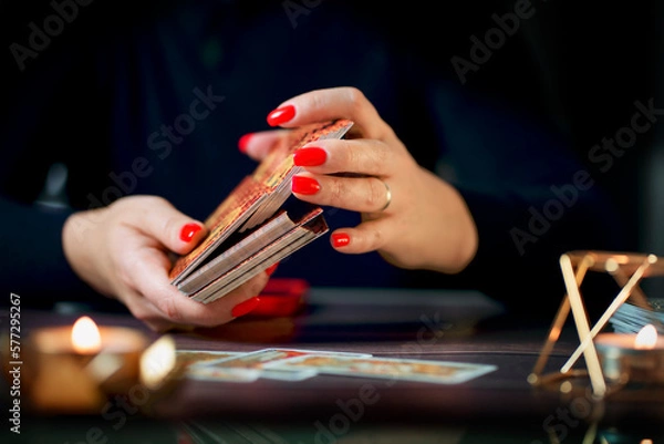 Fototapeta Selective Focus of two hands shuffling and adjusting tarot cards