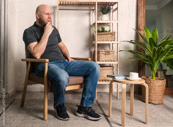 Fototapeta Bold bearded man is doing his interview in home office 