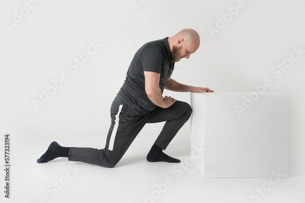 Fototapeta Man is doing exercises. Isolated . White background